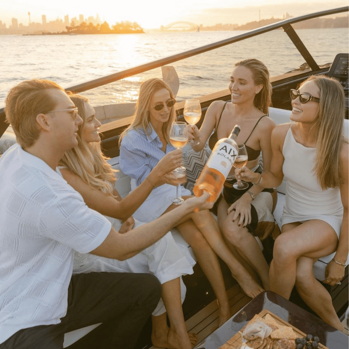 People on boat toasting with wine.