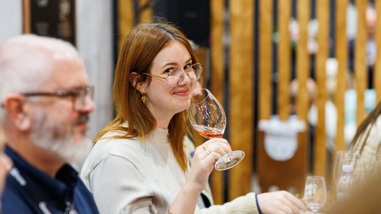 Woman tasting rosé wine at the Good Food & Wine Show.