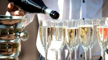 Sparkling wine being poured into flutes.