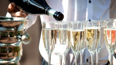 Sparkling wine being poured into flutes.