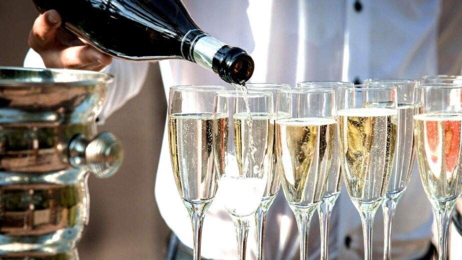 Sparkling wine being poured into flutes.