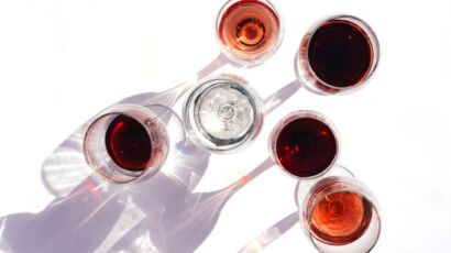 Assorted wine glasses filled with red, white, and rosé wines