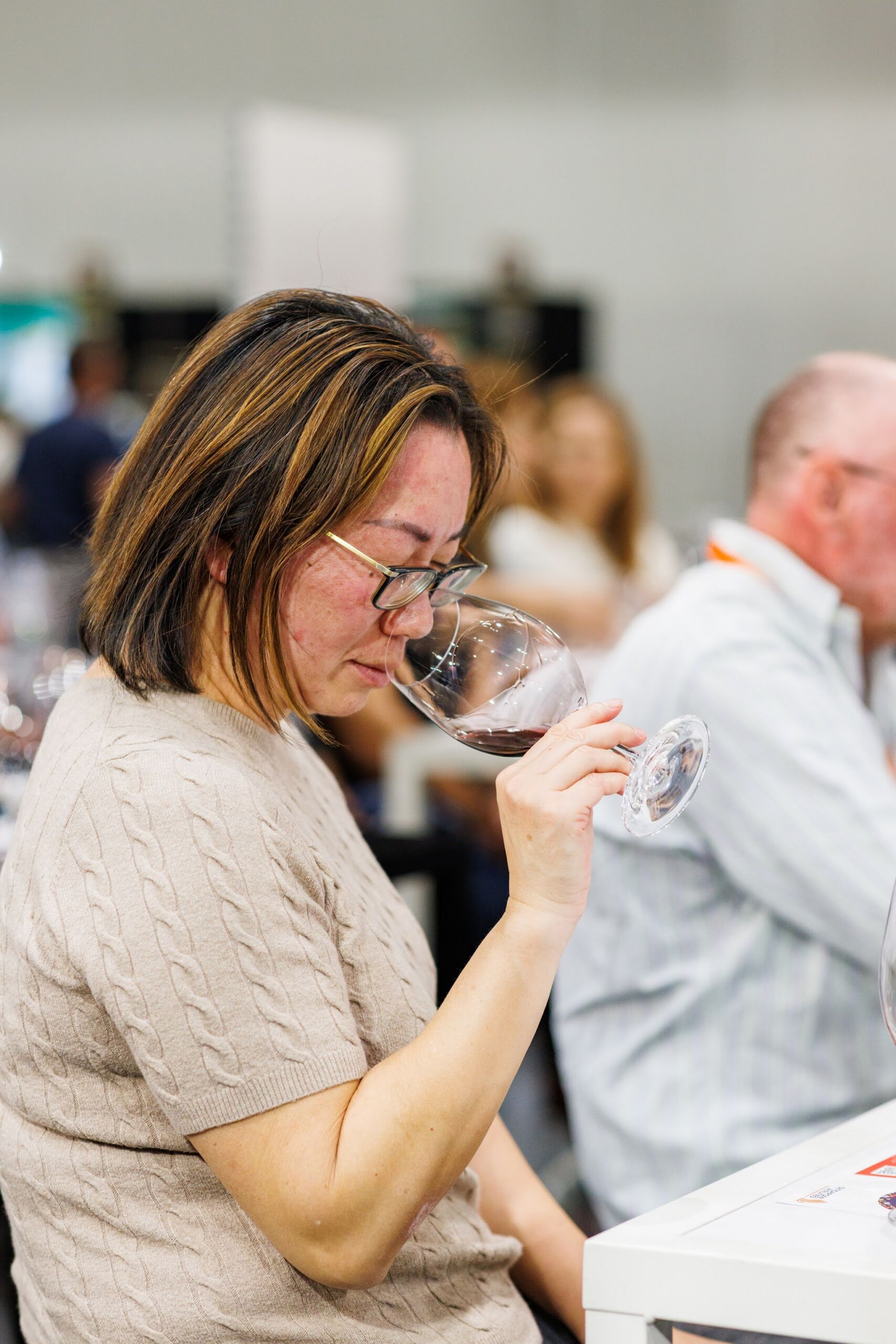 Woman smelling and appreciating the aroma of wine during a Drinks Lab session at the Good Food & Wine Show.