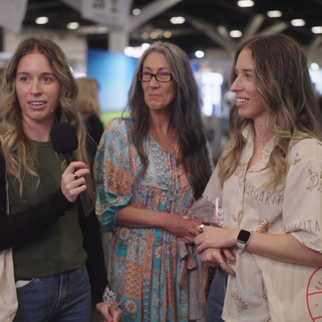 Three women being interviewed at the Good Food & Wine Show, smiling and enjoying the event.