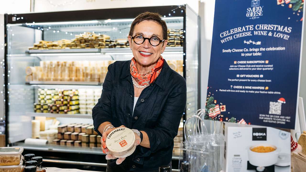 Valerie Henbest folding a block of Camembert cheese at the Good Food & Wine Show.