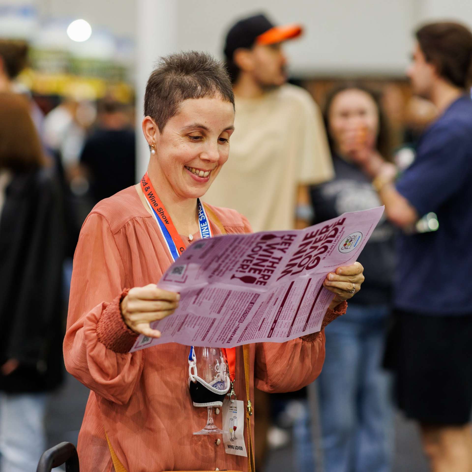 Woman holding a Wine Lovers Guide at the Good Food & Wine Show