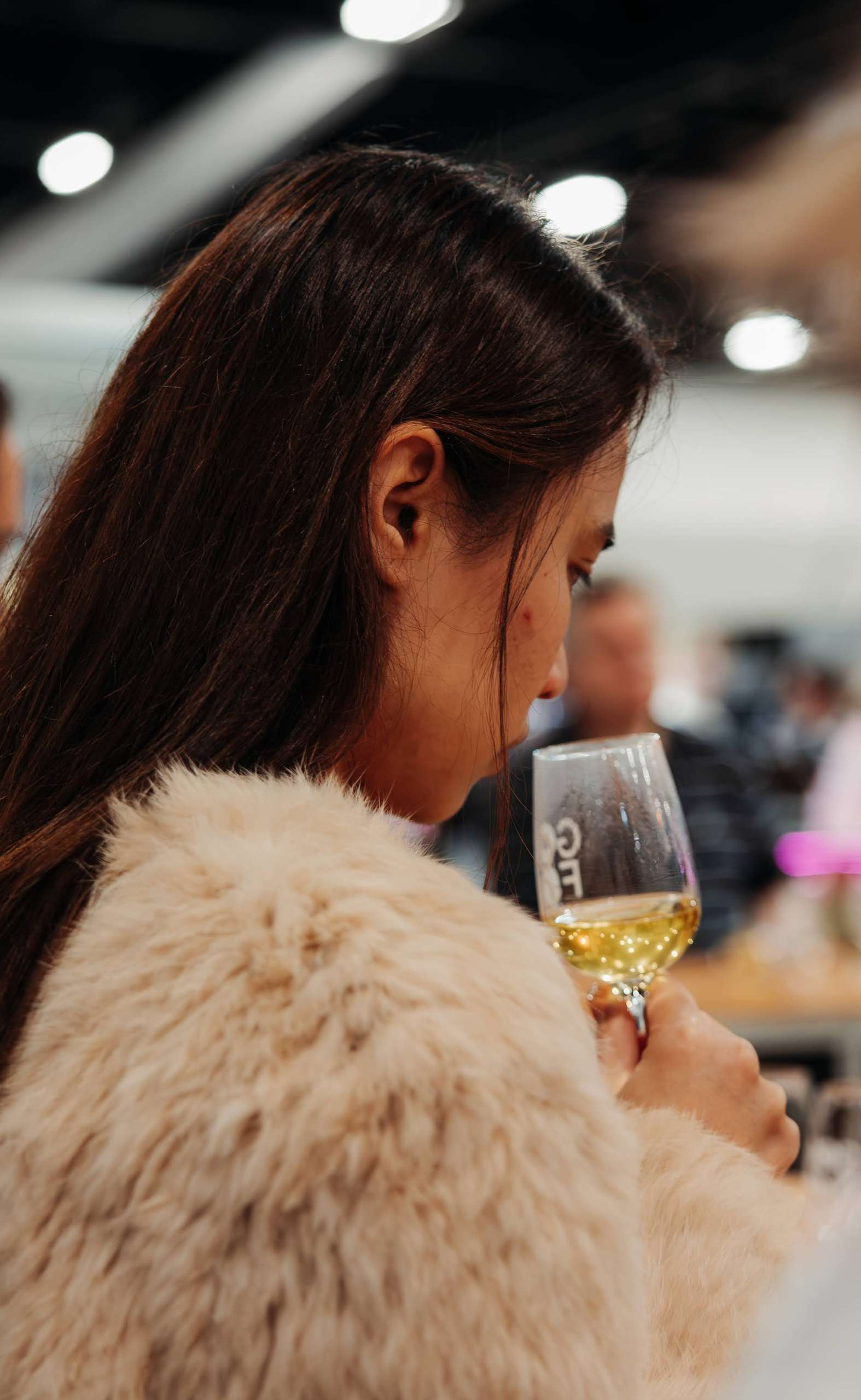 Woman smelling a glass of tea during a tasting masterclass at the Dilmah Tea School at the Good Food & Wine Show.
