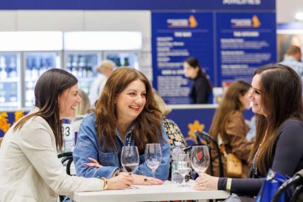 Three women enjoying drinks in the VIP Lounge presented by Singapore Airlines at the Good Food & Wine Show