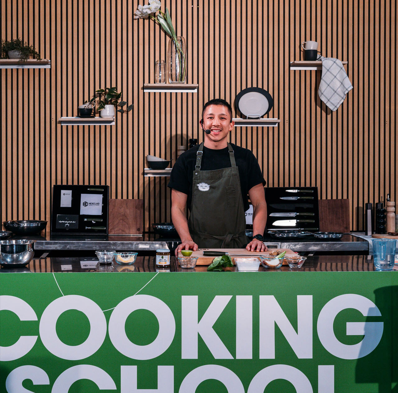 Chef Brendan Pang showcases dumpling-making techniques with a smile on the main stage at the Good Food & Wine Show.