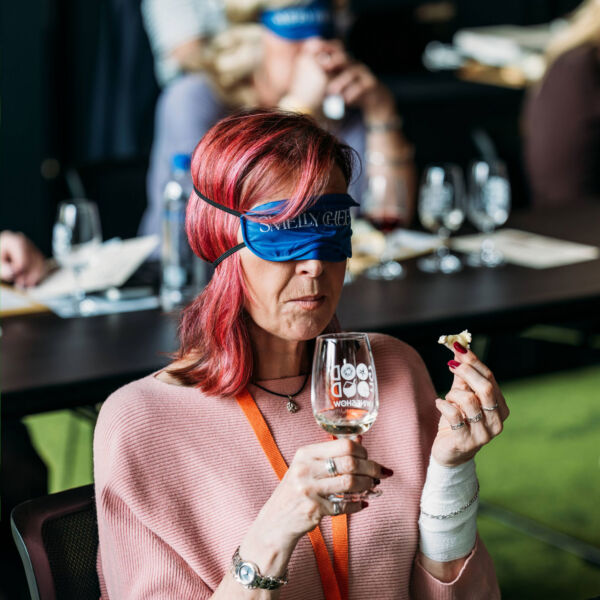 An attendee raises a glass of champagne during the Cheese, Champagne & Caviar Masterclass at the Good Food & Wine Show, enjoying a premium guided tasting experience.