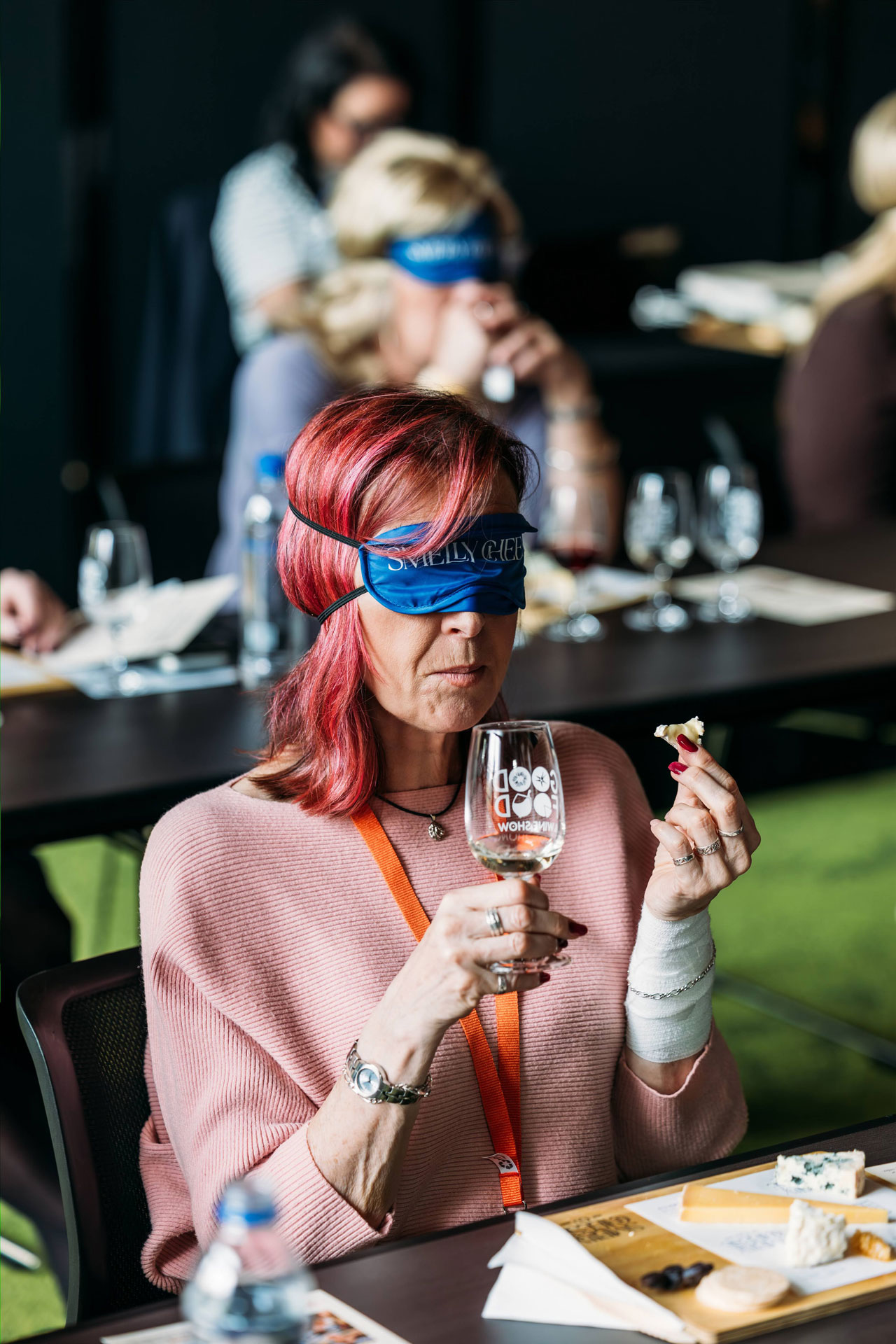 An attendee raises a glass of champagne during the Cheese, Champagne & Caviar Masterclass at the Good Food & Wine Show, enjoying a premium guided tasting experience.