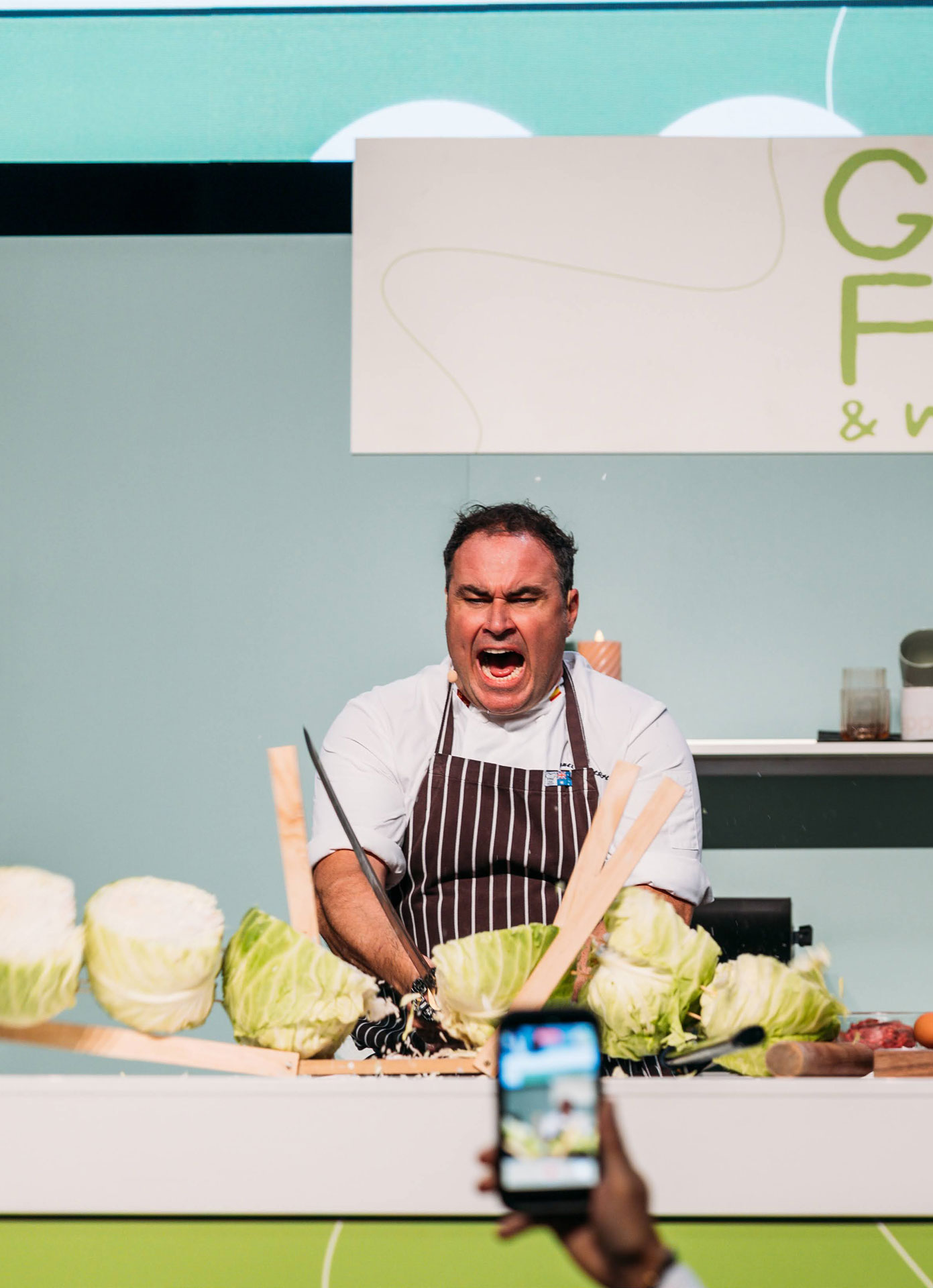 Miguel Maestre giving products to the crowd at the Good Food & Wine Show cooking stage
