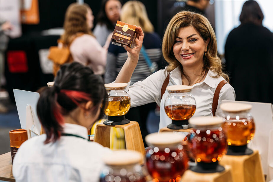 Woman smile, enjoying the tasting experiences at the Good Food & Wine Show.