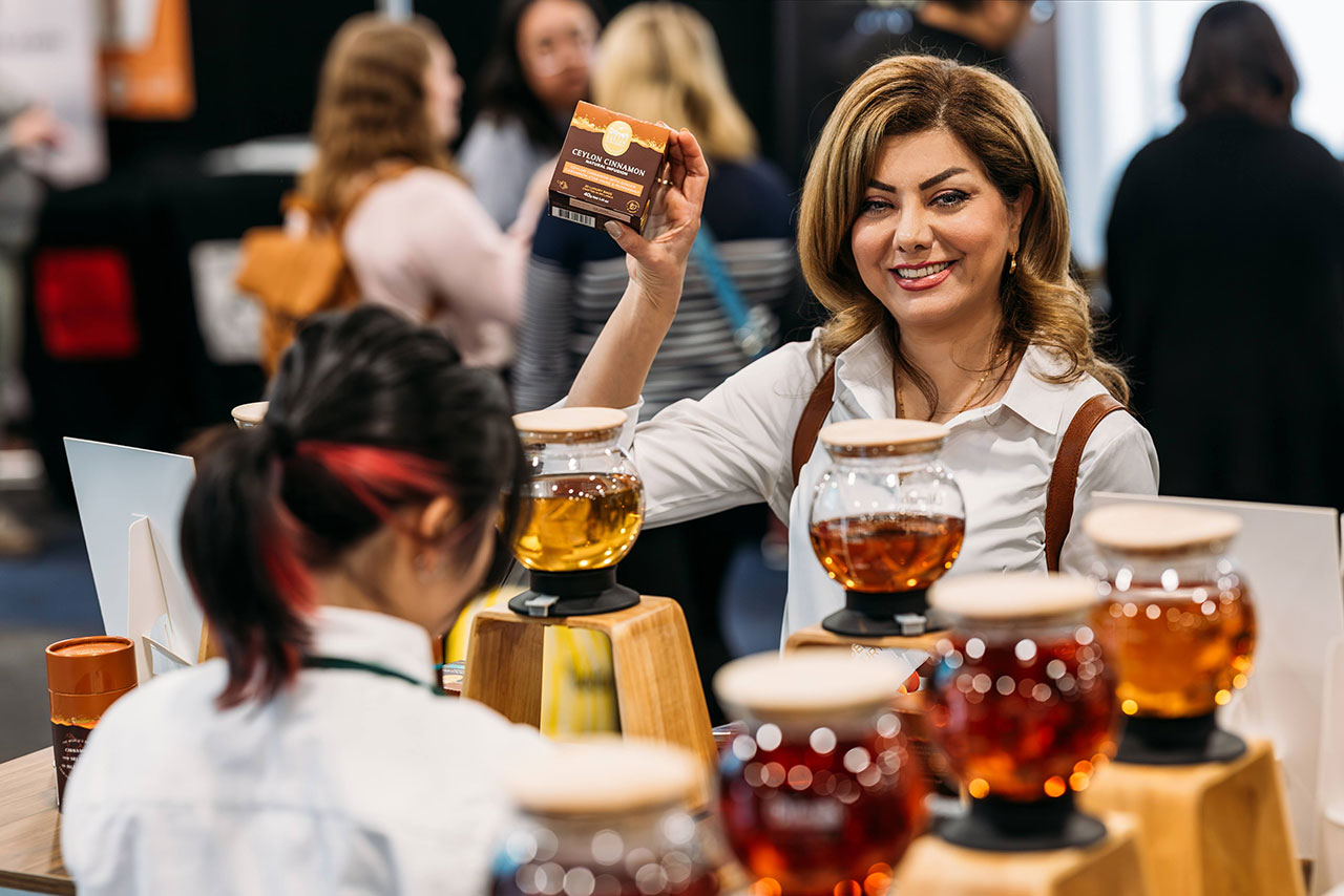 Woman smile, enjoying the tasting experiences at the Good Food & Wine Show.