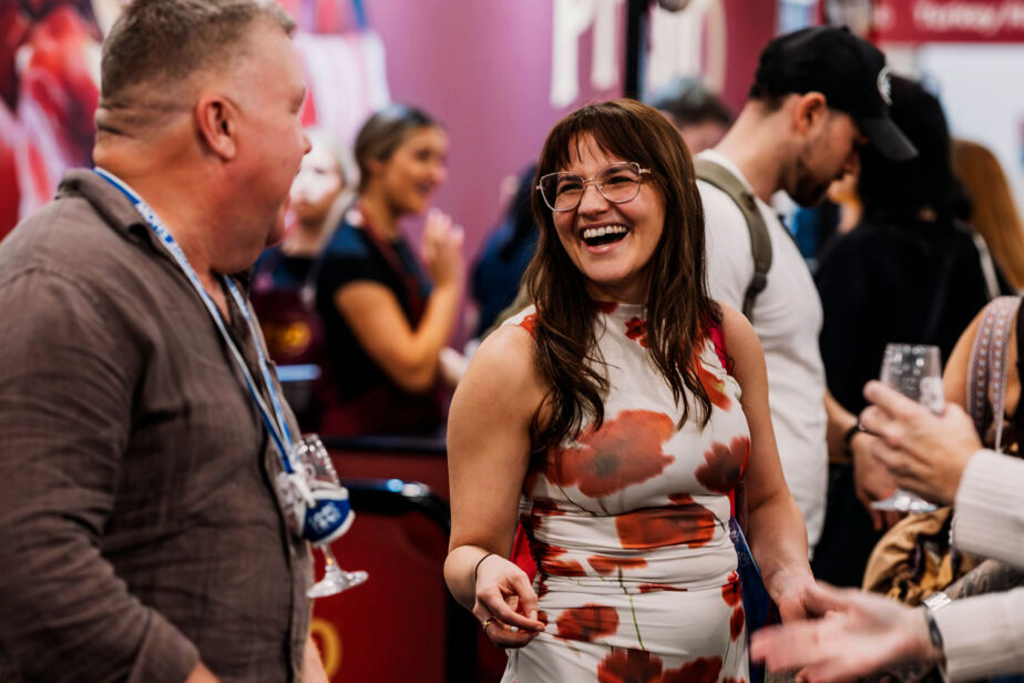 Woman smile, enjoying the tasting experiences at the Good Food & Wine Show.