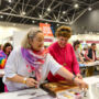 Two women are at the Live cooking Masterclass at the Good Food & Wine Show christmas Edition