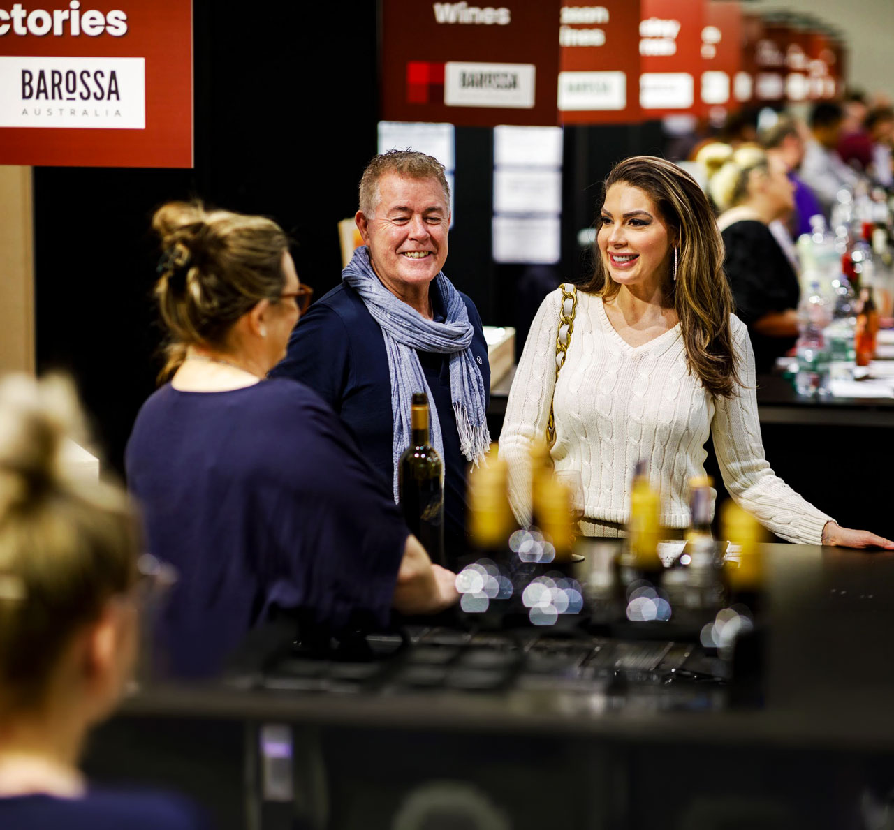 Wine exhibitor pouring a tasting for a guest at the Good Food & Wine Show in Brisbane.